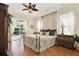 Spacious main bedroom with wood floors, ceiling fan, and access to the outdoor patio at 995 Hidden Blf, Clermont, FL 34711