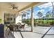 Outdoor patio featuring a dining area, and a scenic pool with lush landscaping at 995 Hidden Blf, Clermont, FL 34711