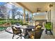 Outdoor patio featuring a dining area, outdoor kitchen, and lush landscaping at 995 Hidden Blf, Clermont, FL 34711