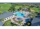 Aerial view of a resort-style pool, with palm trees, a gazebo, and lounge chairs at 995 Hidden Blf, Clermont, FL 34711