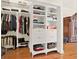 Spacious walk-in closet featuring custom shelving units for optimal organization at 995 Hidden Blf, Clermont, FL 34711