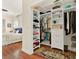Walk-in closet with custom shelving and ample storage space, steps away from the main bedroom at 995 Hidden Blf, Clermont, FL 34711