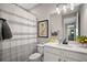 A clean bathroom featuring a striped shower curtain and modern fixtures at 10177 Spring Lake Dr, Clermont, FL 34711