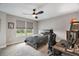 Comfortable bedroom with a ceiling fan, natural light, and desk set up for working at home at 10177 Spring Lake Dr, Clermont, FL 34711