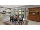 Dining area with adjacent kitchen, an outdoor view, and vintage furniture at 10177 Spring Lake Dr, Clermont, FL 34711