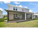 Rear exterior view of the house highlighting the screened patio and spacious backyard at 10177 Spring Lake Dr, Clermont, FL 34711