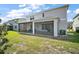 Exterior view showcasing the house's screened patio and outdoor living space at 10177 Spring Lake Dr, Clermont, FL 34711