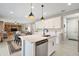 Modern kitchen features a center island with a sink and sleek, white cabinetry at 10177 Spring Lake Dr, Clermont, FL 34711