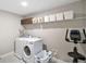 Functional laundry room with modern appliances, overhead storage, and a convenient layout at 10177 Spring Lake Dr, Clermont, FL 34711