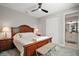 Cozy main bedroom featuring wooden furnishings and an ensuite bathroom at 10177 Spring Lake Dr, Clermont, FL 34711