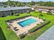 Elevated view of the community pool, showcasing the surrounding residential buildings and well-maintained landscaping at 1100 E Caroline St # 218, Tavares, FL 32778