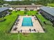 Aerial view of the community pool, showcasing the lush landscaping and surrounding residential buildings at 1100 E Caroline St # 218, Tavares, FL 32778