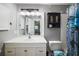 Bright bathroom featuring a white vanity with a spacious countertop and storage, toilet and decorative shower curtain at 1100 E Caroline St # 218, Tavares, FL 32778