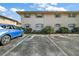 Exterior shot of the apartment building and reserved parking lot, showcasing ample parking and well-maintained grounds at 1100 E Caroline St # 218, Tavares, FL 32778