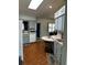 Kitchen with light grey cabinets, wood floors, and a skylight, offering a bright, airy atmosphere at 1108 Ben Hope Dr, Leesburg, FL 34788