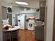 Well-lit kitchen with grey cabinetry, white appliances, and a cozy breakfast nook at 1108 Ben Hope Dr, Leesburg, FL 34788