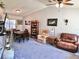 A view of the open-concept living room with vaulted ceilings, ceiling fan, and neutral gray walls at 1108 Ben Hope Dr, Leesburg, FL 34788