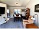 This is a view of the living room with a vaulted ceiling, ceiling fan, and neutral gray walls at 1108 Ben Hope Dr, Leesburg, FL 34788