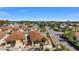 An aerial view of a residential neighborhood featuring well-maintained homes with lush landscaping at 1202 San Bernardo Rd, The Villages, FL 32162