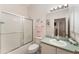 Well-lit bathroom featuring a shower/tub combo and vanity with mint countertop at 1202 San Bernardo Rd, The Villages, FL 32162