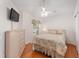 Comfortable bedroom featuring hardwood floors, a ceiling fan, a window, and a closet at 1202 San Bernardo Rd, The Villages, FL 32162