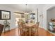 Bright dining area with wood floors, contemporary lighting, and backyard view at 1202 San Bernardo Rd, The Villages, FL 32162