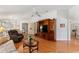 Warm living area with wood flooring, seating area and archway to the dining area at 1202 San Bernardo Rd, The Villages, FL 32162