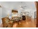 Cozy living room featuring hardwood floors, seating area and seamless dining area access at 1202 San Bernardo Rd, The Villages, FL 32162