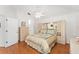 Cozy main bedroom with hardwood floor, cabinet headboard and bright view window at 1202 San Bernardo Rd, The Villages, FL 32162