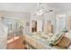 Bright main bedroom with a ceiling fan, sliding glass door, and ensuite bathroom, offering a relaxing retreat at 1202 San Bernardo Rd, The Villages, FL 32162