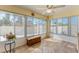 Cozy sunroom featuring ample windows, tile flooring, and a ceiling fan, perfect for relaxation and entertaining at 1202 San Bernardo Rd, The Villages, FL 32162