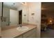 Bathroom featuring a single sink vanity and view into the primary bedroom at 1215 Eagle Ridge Dr, The Villages, FL 32162