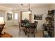 Dining area featuring a glass-topped table with seating for four and neutral decor at 1215 Eagle Ridge Dr, The Villages, FL 32162