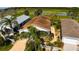 Home exterior showing the driveway and landscaped garden with palm trees in front of a well-maintained yard at 1215 Eagle Ridge Dr, The Villages, FL 32162