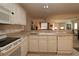 Bright kitchen featuring a breakfast bar that overlooks the cozy living room at 1215 Eagle Ridge Dr, The Villages, FL 32162