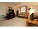 Cozy living room featuring a rattan sofa, entertainment center, and ceiling fan at 1215 Eagle Ridge Dr, The Villages, FL 32162