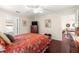 Comfortable bedroom with hardwood floors, ceiling fan, and decorative accents at 12225 Se 173Rd Pl, Summerfield,, FL 34491