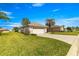 Exterior view of a home with a large, well-manicured lawn and a two-car garage at 12225 Se 173Rd Pl, Summerfield,, FL 34491