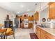 Well-lit kitchen with stainless steel refrigerator and tile flooring at 12225 Se 173Rd Pl, Summerfield,, FL 34491