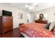 Cozy main bedroom with a dresser and a view into the adjoining bathroom at 12225 Se 173Rd Pl, Summerfield,, FL 34491