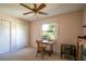 Bedroom featuring a ceiling fan, closet, and desk next to a window at 12418 Clubhouse Ct, Tavares, FL 32778