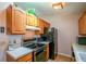 Well-lit kitchen featuring wood cabinets, stainless steel appliances, and a laminate countertop at 12418 Clubhouse Ct, Tavares, FL 32778