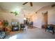 Bright living room featuring neutral carpet and a view into the dining area at 12418 Clubhouse Ct, Tavares, FL 32778