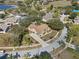 Aerial view of a landscaped property with a circular driveway, mature trees, and neighborhood streets at 12626 Douglas Fir Ct, Clermont, FL 34711