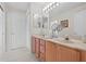 Bright bathroom featuring double sinks, ample counter space, and stylish fixtures for a comfortable experience at 12626 Douglas Fir Ct, Clermont, FL 34711