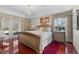 Bedroom featuring a chandelier, a carved wooden bed frame, wood floors, and access to the outdoors at 12626 Douglas Fir Ct, Clermont, FL 34711