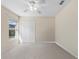 Bright bedroom with a ceiling fan, plush carpet and large closet at 12626 Douglas Fir Ct, Clermont, FL 34711