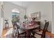 Formal dining room with hardwood floors, a decorative chandelier and lots of natural light at 12626 Douglas Fir Ct, Clermont, FL 34711