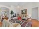 Cozy living room featuring hardwood floors, a decorative chandelier and lots of seating at 12626 Douglas Fir Ct, Clermont, FL 34711