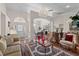 Bright living room featuring hardwood floors, a decorative chandelier and lots of seating at 12626 Douglas Fir Ct, Clermont, FL 34711